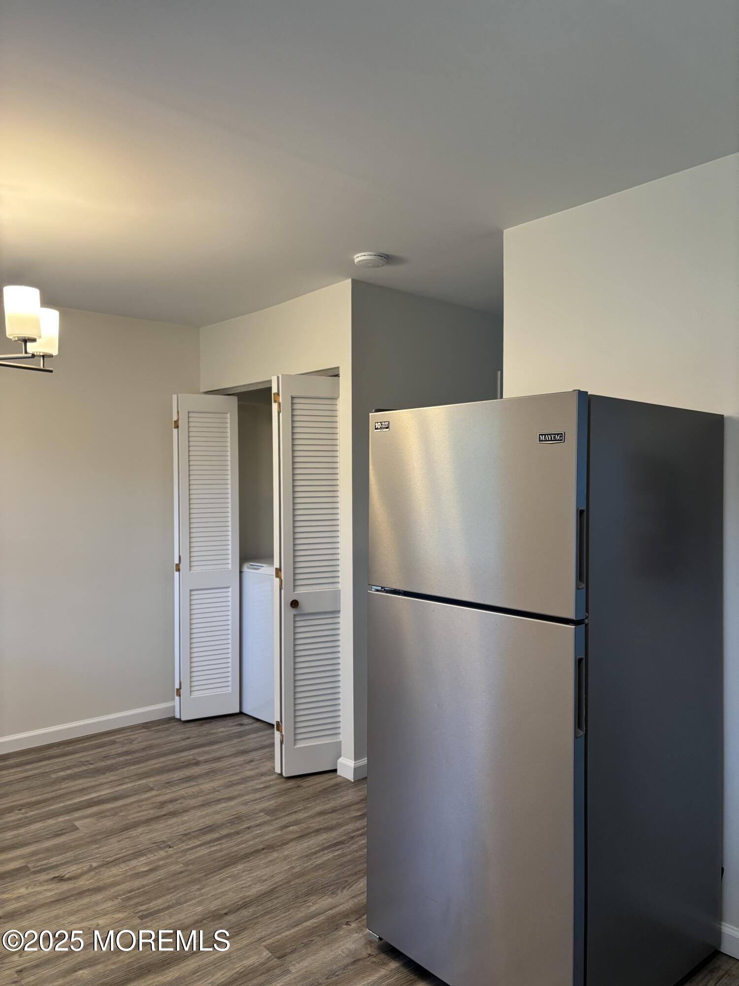159 Village Green Way Hazlet, NJ 07730 - Photo 7 of 17 a white refrigerator freezer and a wooden floor