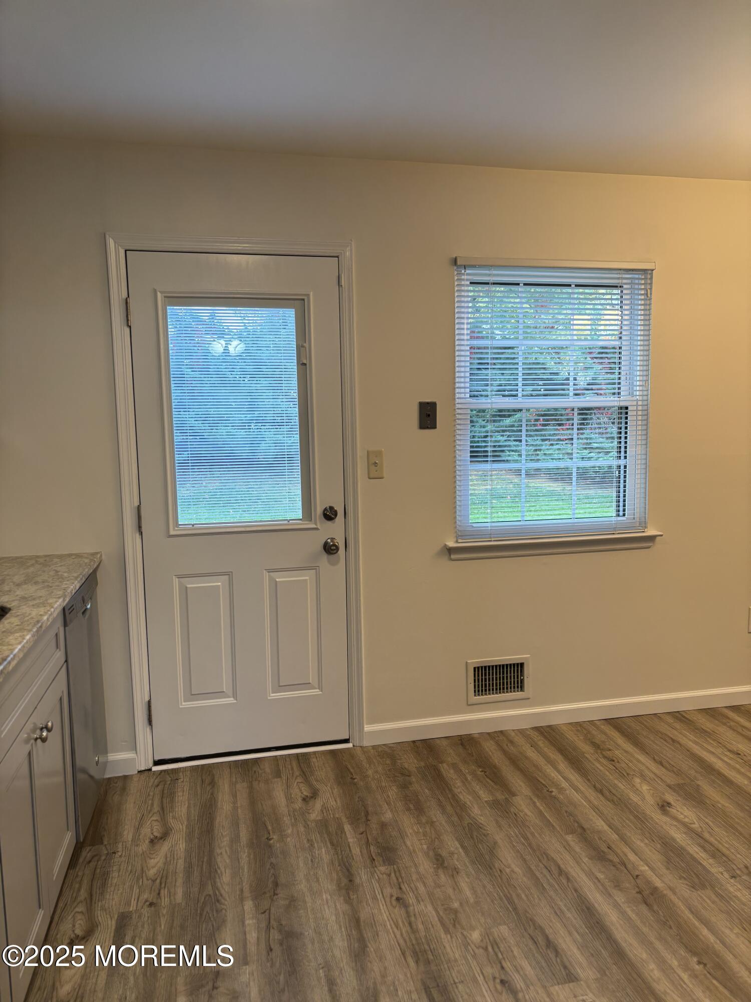 159 Village Green Way Hazlet, NJ 07730 - Photo 9 of 17 an empty room with wooden floor and windows