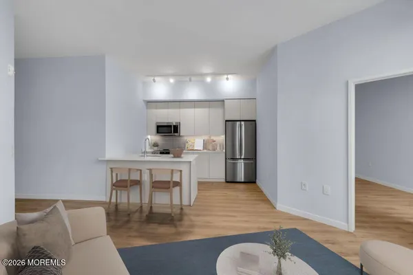 a dining room with furniture and wooden floor