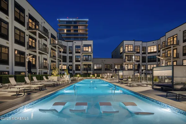 a swimming pool view with a outdoor seating