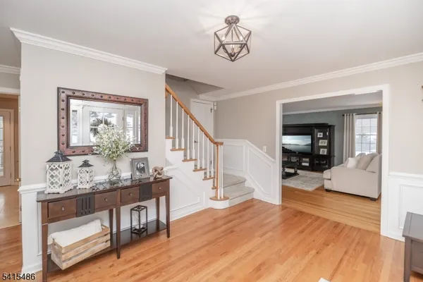 a dining room with furniture window and wooden floor
