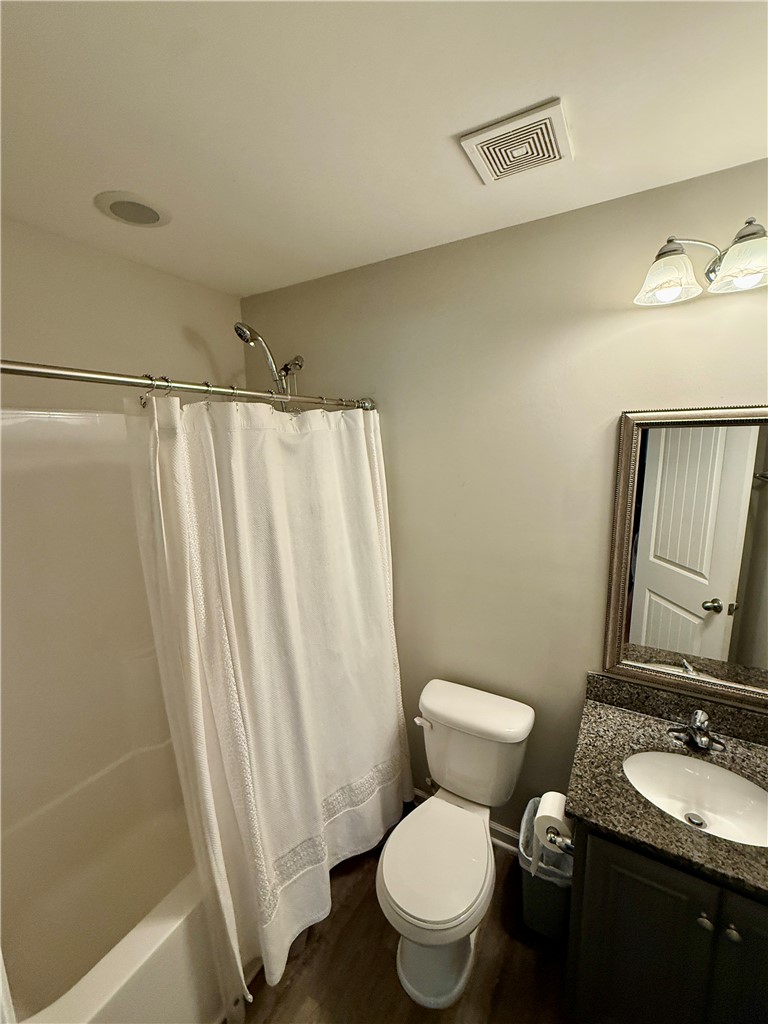 417 Laurel Grove Court Seneca, SC 29678 - Photo 6 of 10 A well-appointed bathroom features a practical tub-shower combination, modern vanity, and polished wood-look flooring.