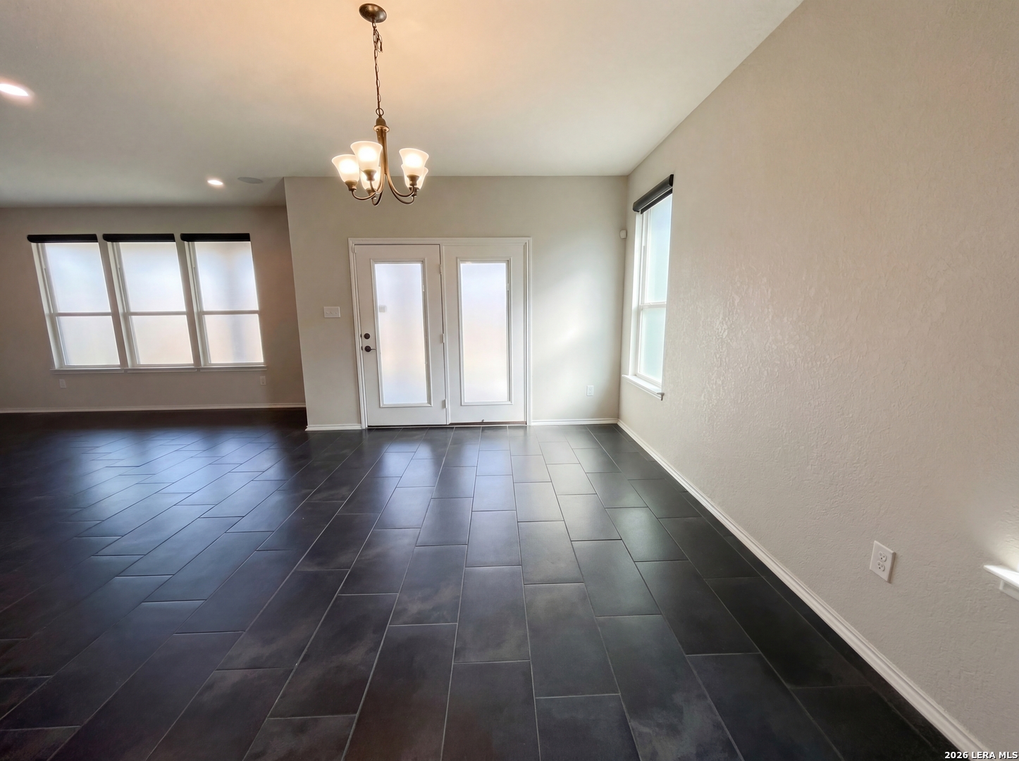 11403 Sawyer Road San Antonio, TX 78238 - Photo 16 of 20 a view of an empty room with wooden floor and a window