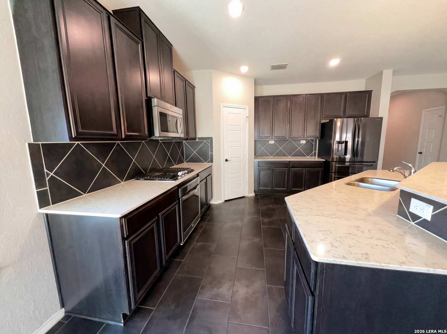 11403 Sawyer Road San Antonio, TX 78238 - Photo 2 of 20 a kitchen with stainless steel appliances granite countertop a sink stove and refrigerator