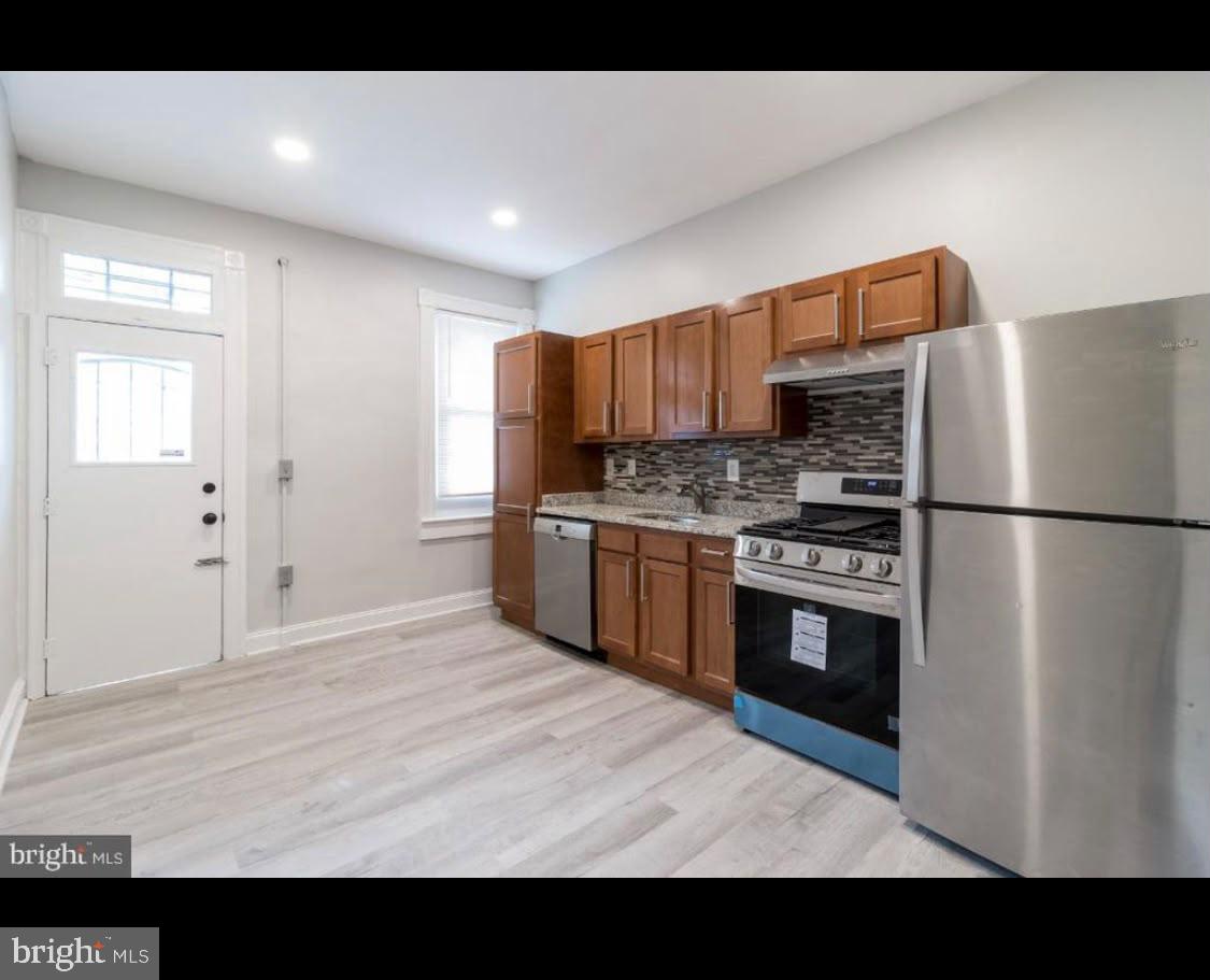 1626 Appleton Street Baltimore, MD 21217 - Photo 12 of 18 a kitchen with stainless steel appliances granite countertop a refrigerator a sink and a stove