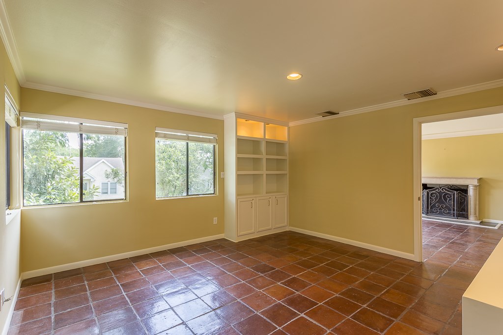 2349 Albans Road, Unit 2 Houston, TX 77005 - Photo 11 of 25 Experience the seamless flow from the versatile dining/flex room or study, bathed in natural light and featuring elegant built-in shelving, as it opens up to a welcoming living room complete with a charming fireplace.