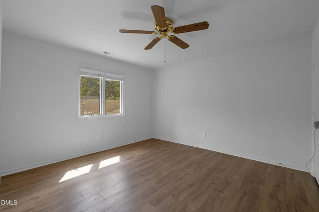 a view of room with hardwood floor and ceiling fan