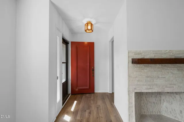 a view of a hallway with wooden floor