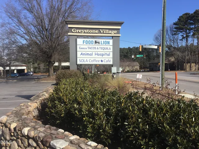 a view of a house with a yard and garden