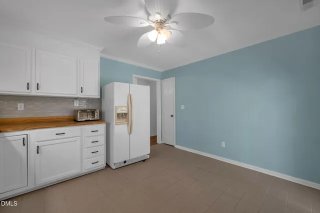 a kitchen with cabinets stainless steel appliances and a window
