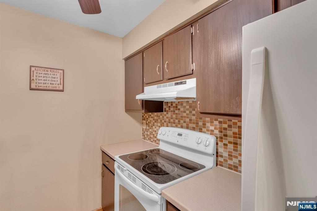 666 Mill Street, Unit C6 Belleville, NJ 07109 - Photo 11 of 25 a kitchen with a stove and a microwave