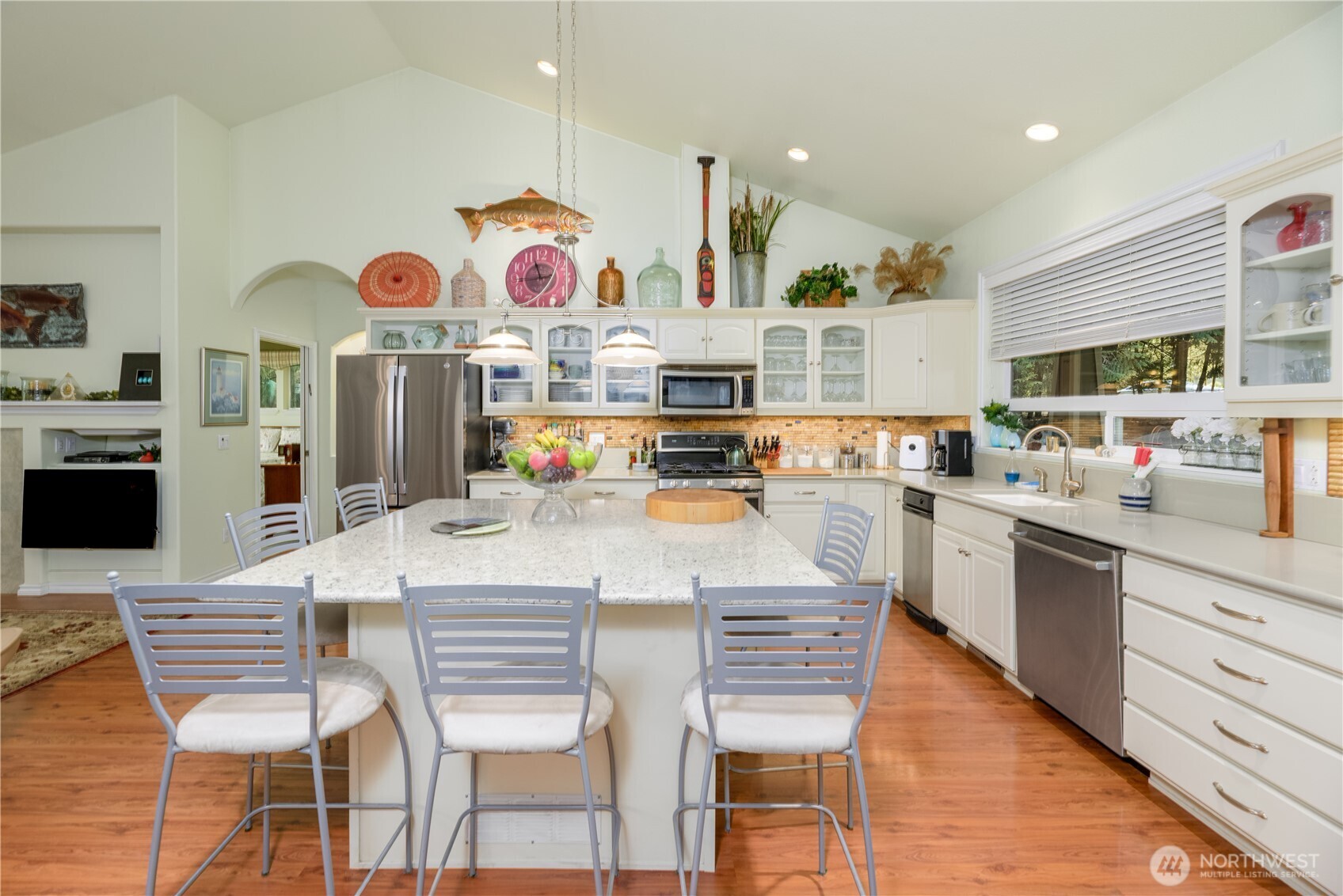 121 Buck Loop Road Sequim, WA 98382 - Photo 12 of 40 a kitchen with stainless steel appliances granite countertop a kitchen island and chairs in it