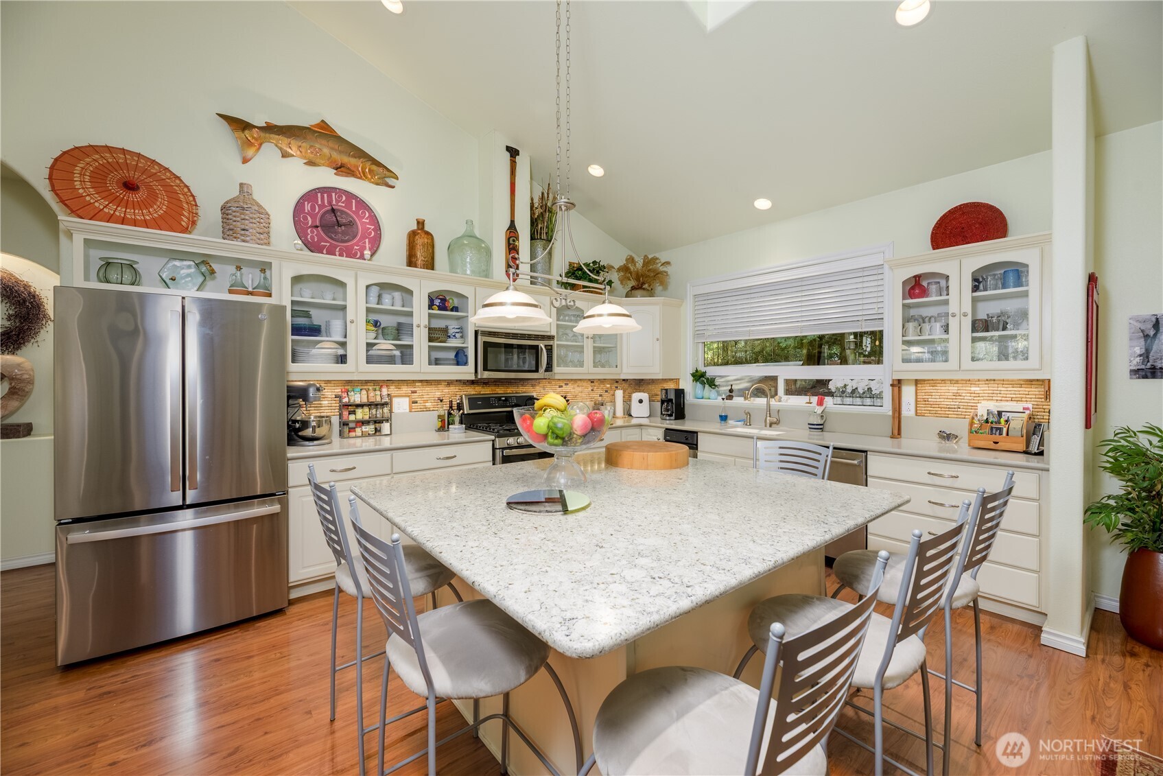 121 Buck Loop Road Sequim, WA 98382 - Photo 14 of 40 a kitchen with stainless steel appliances granite countertop a sink dishwasher and refrigerator with wooden floor