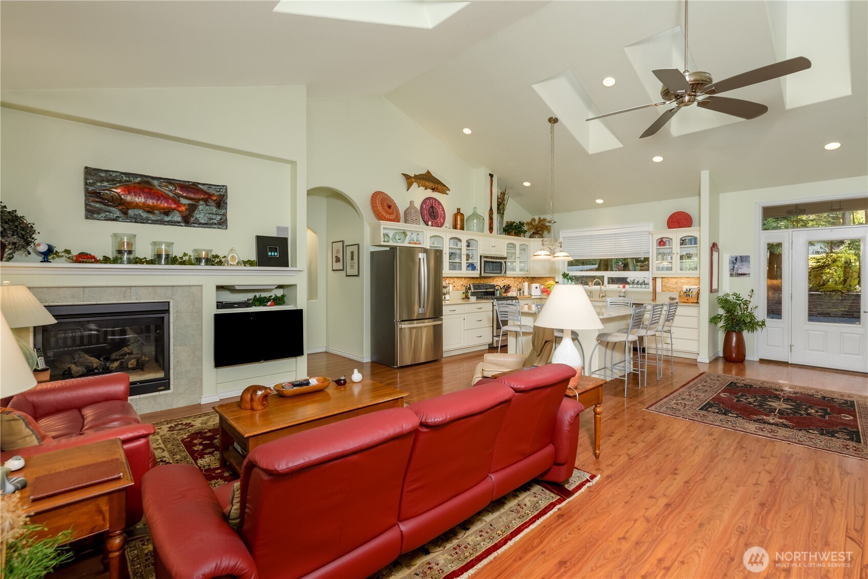 121 Buck Loop Road Sequim, WA 98382 - Photo 19 of 40 a living room with furniture a fireplace and a flat screen tv
