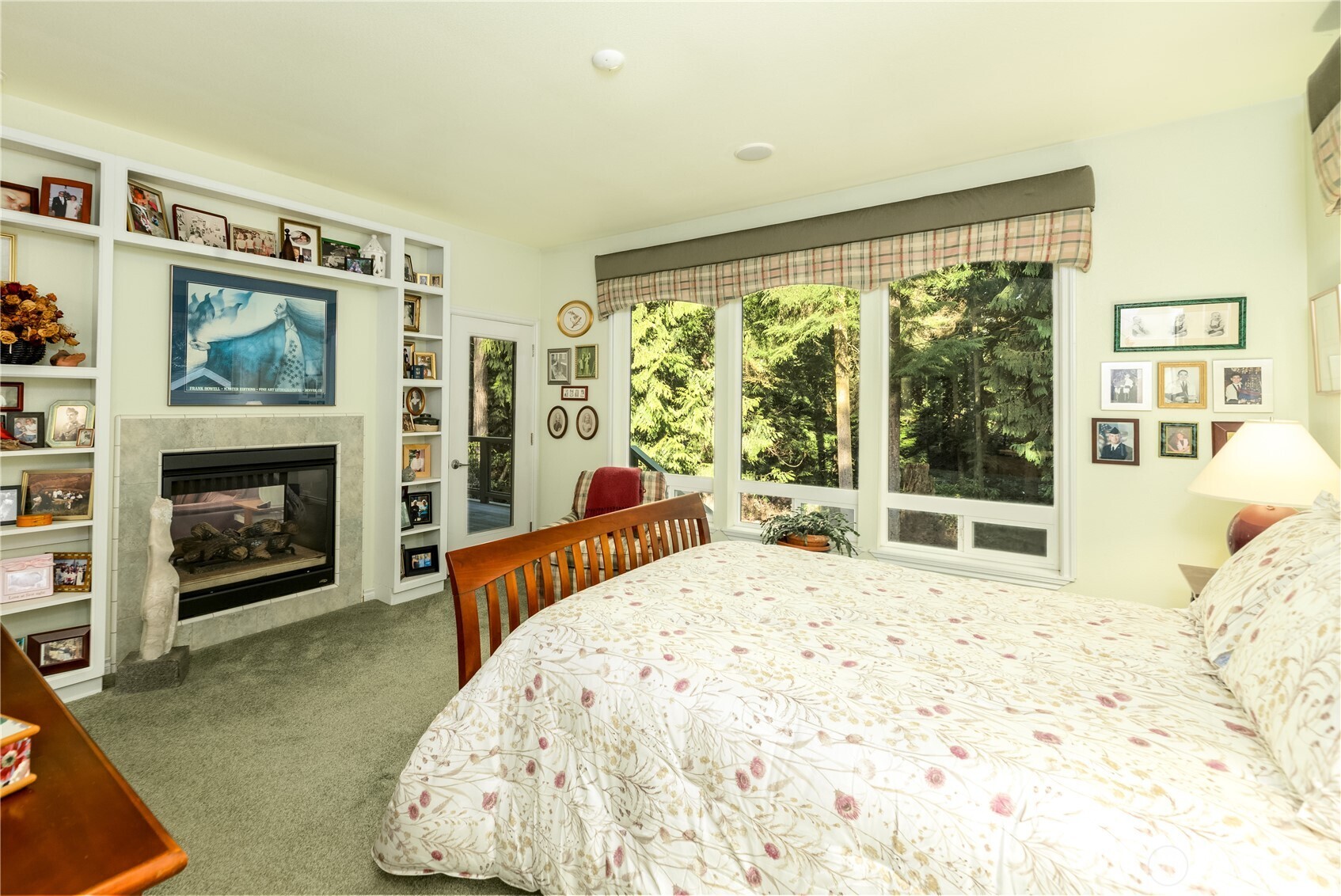 121 Buck Loop Road Sequim, WA 98382 - Photo 24 of 40 a bedroom with a bed and a fireplace