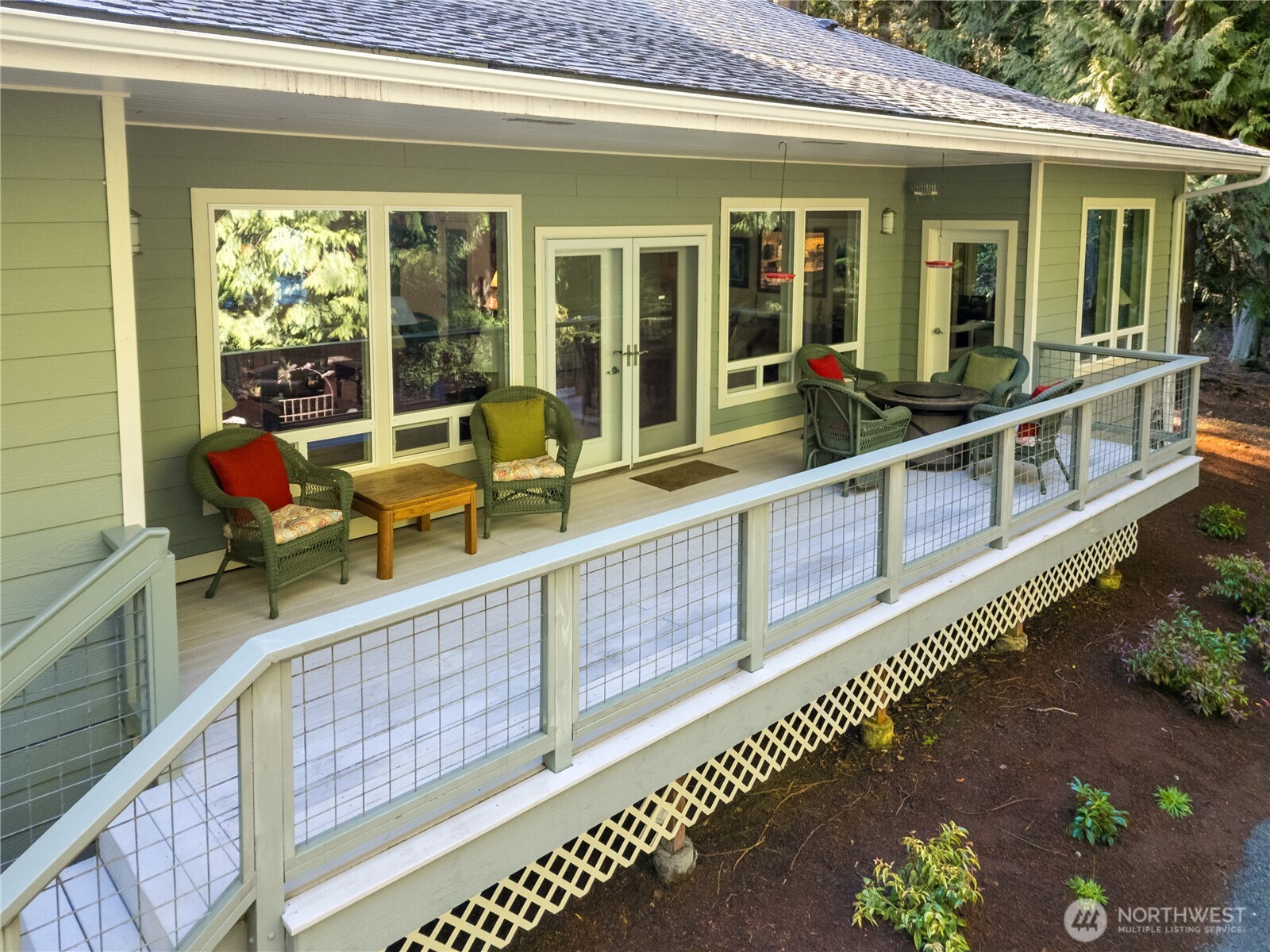 121 Buck Loop Road Sequim, WA 98382 - Photo 35 of 40 a view of a house with wooden floor and outdoor seating