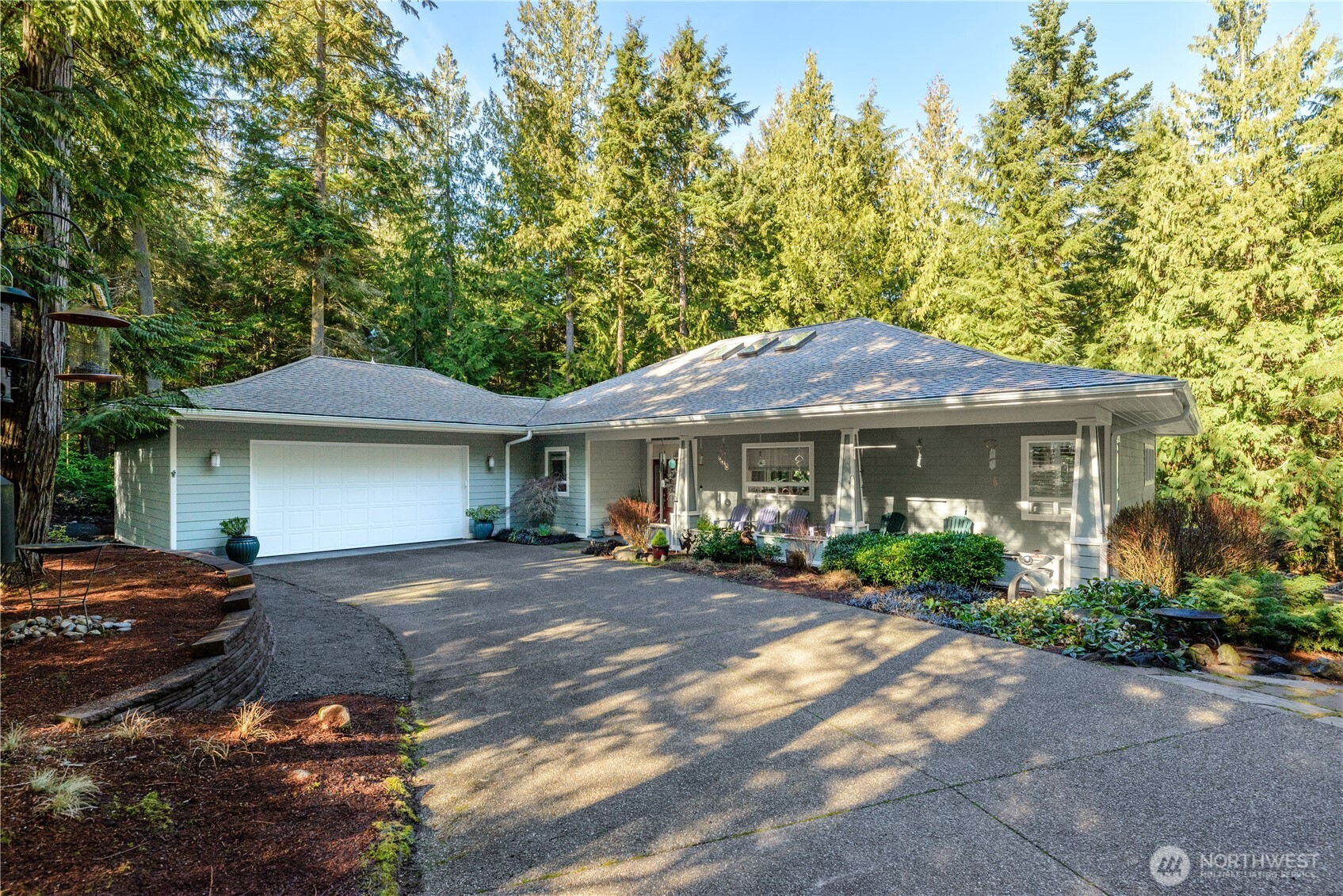 121 Buck Loop Road Sequim, WA 98382 - Photo 4 of 40 a front view of a house with a garden
