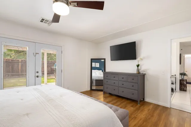 a view of an empty room with closet and a bathroom