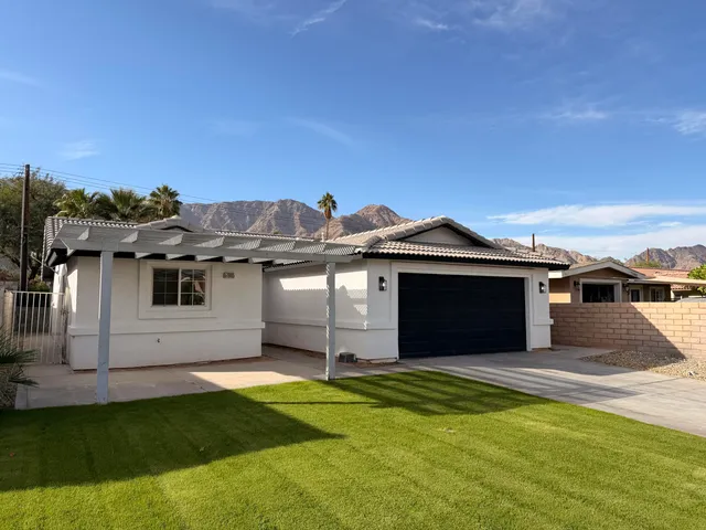 a front view of a house with a garden