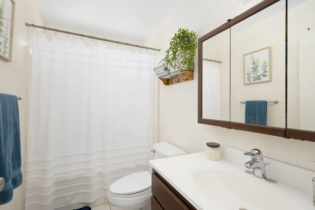 a kitchen with granite countertop a refrigerator and a stove top oven