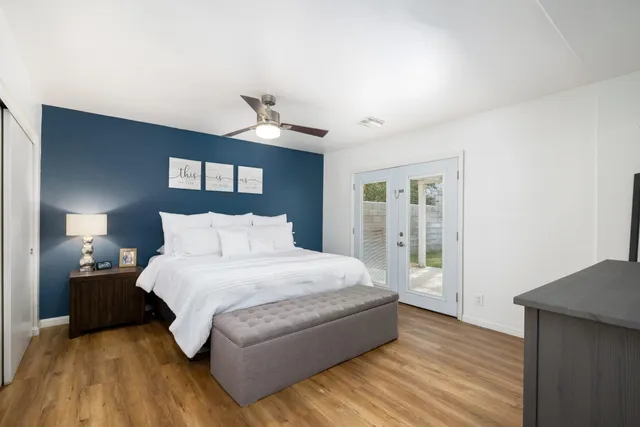 a living room with furniture and a baby crib