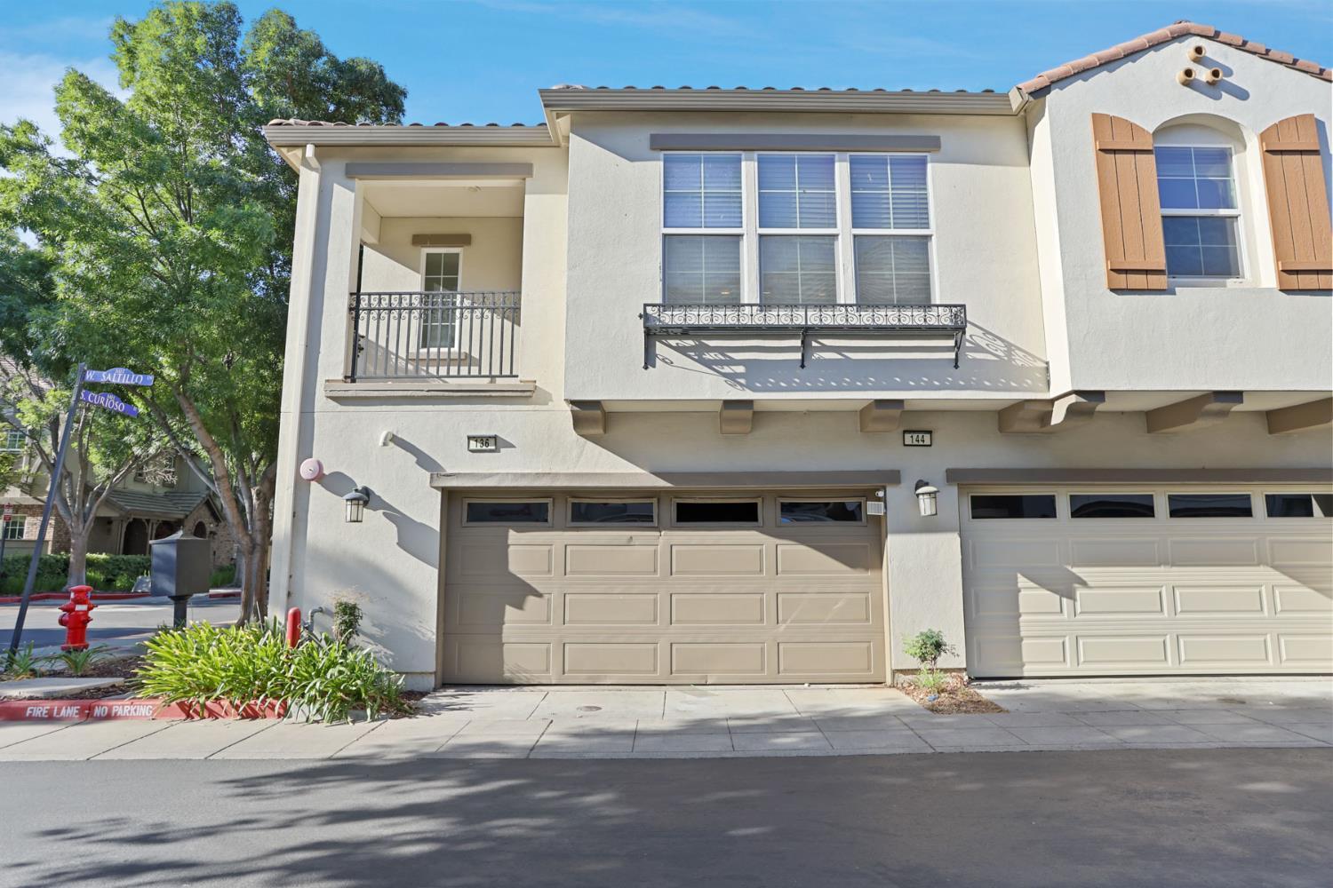 136 West Saltillo Lane Tracy, CA 95391 - Photo 2 of 3 a front view of a house with a yard and garage