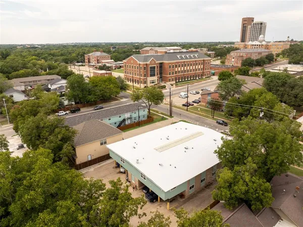 an aerial view of a house with a yard and lake view