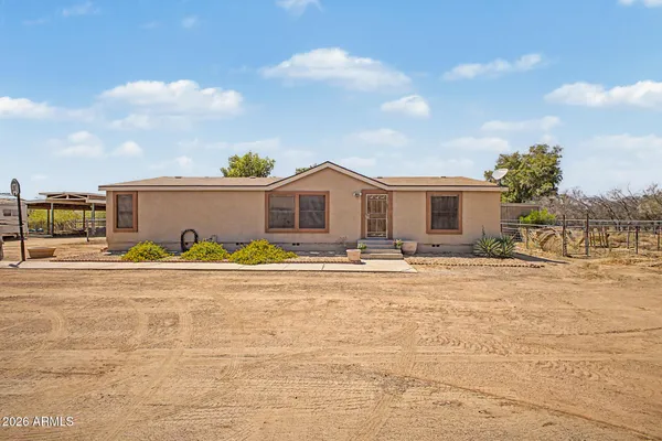 a view of a house with a swimming pool and a yard