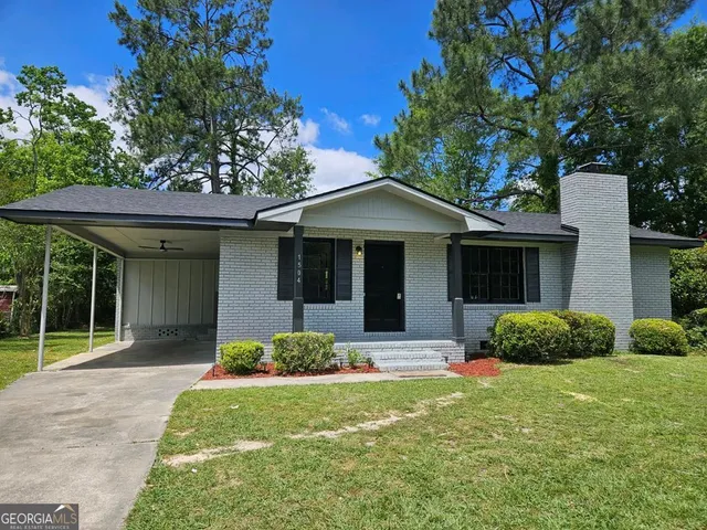 a front view of a house with a yard and porch
