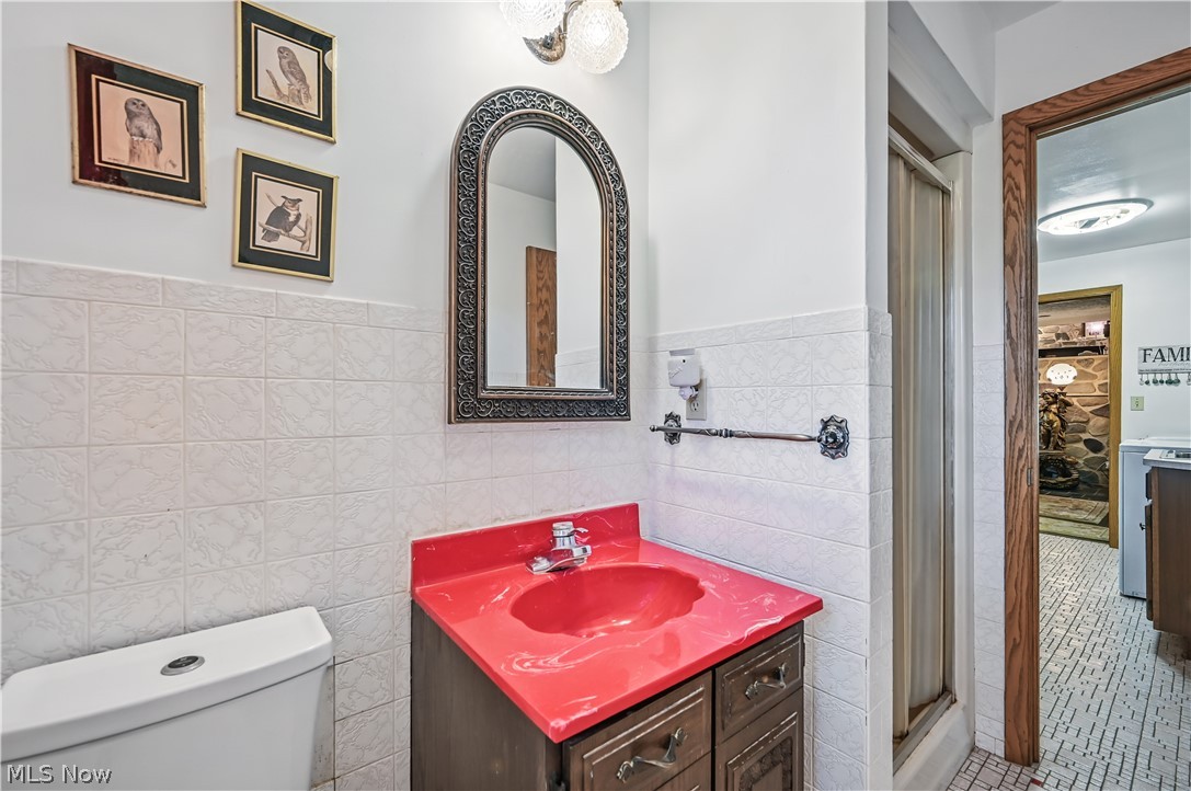 2717 Niles Vienna Road Niles, OH 44446 - Photo 20 of 50 Bathroom featuring tile walls, vanity, a shower stall, a wainscoted wall, and tile patterned flooring