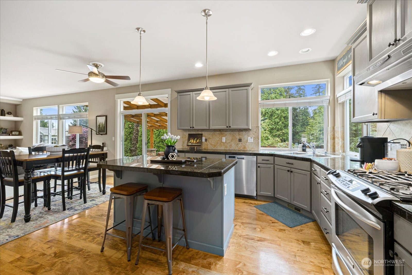 428 199th Place Southeast Bothell, WA 98012 - Photo 8 of 40 a kitchen with a stove a sink a dining table and chairs