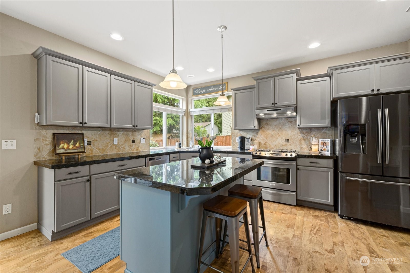 428 199th Place Southeast Bothell, WA 98012 - Photo 10 of 40 a kitchen with stainless steel appliances granite countertop a sink a stove a refrigerator and island