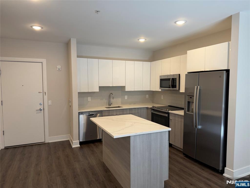 470 Main Street, Unit 508 Fort Lee, NJ 07024 - Photo 1 of 18 a kitchen with stainless steel appliances granite countertop a refrigerator a stove a sink and a microwave
