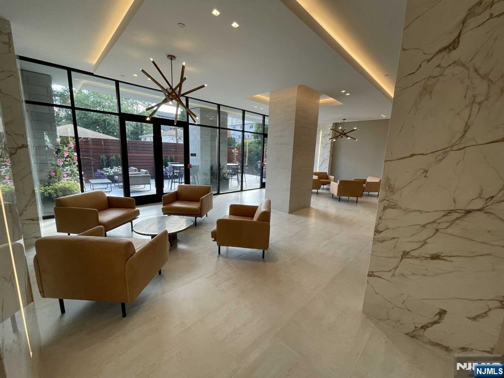 470 Main Street, Unit 508 Fort Lee, NJ 07024 - Photo 14 of 18 a living room with furniture and a floor to ceiling window