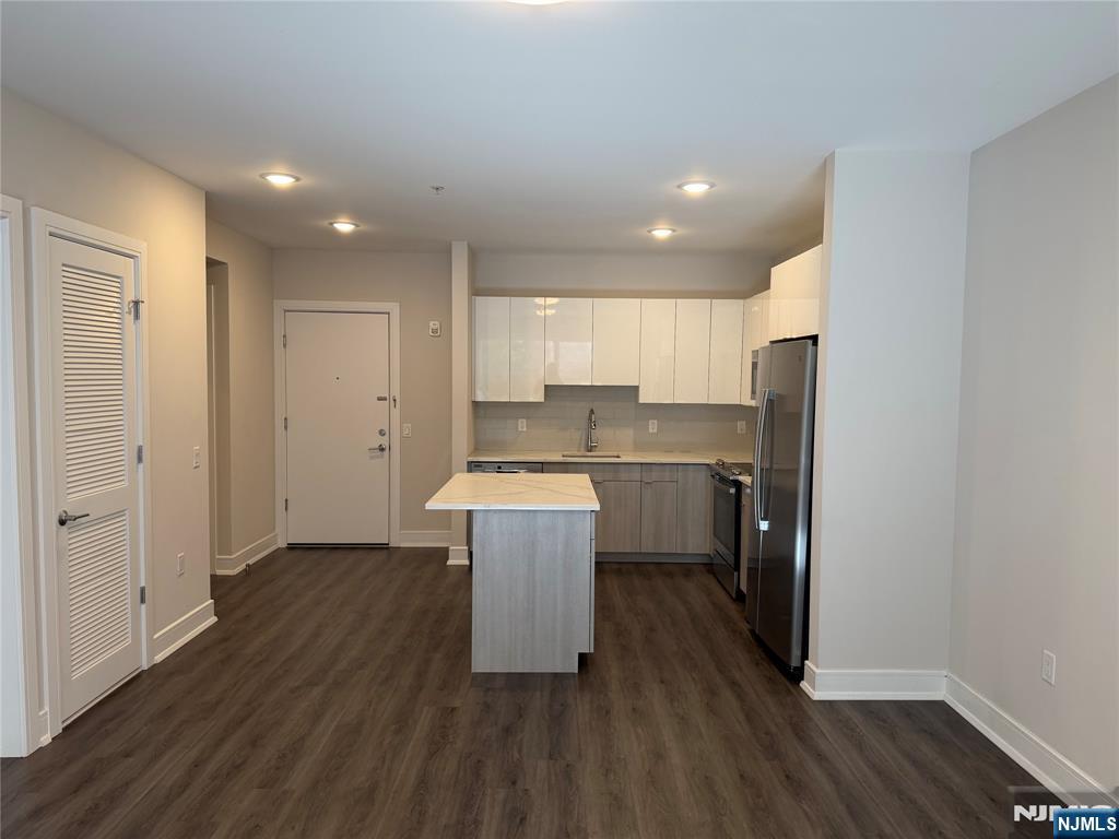 470 Main Street, Unit 508 Fort Lee, NJ 07024 - Photo 3 of 18 a kitchen with a refrigerator a sink and wooden floor