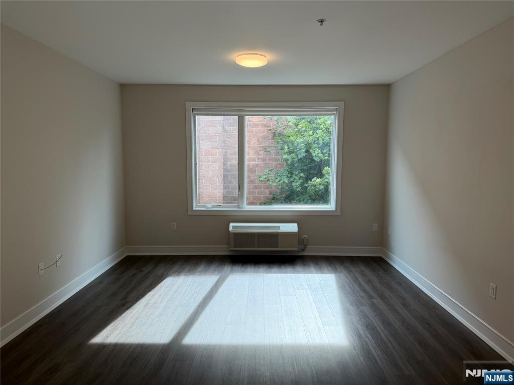 470 Main Street, Unit 508 Fort Lee, NJ 07024 - Photo 4 of 18 an empty room with wooden floor and windows