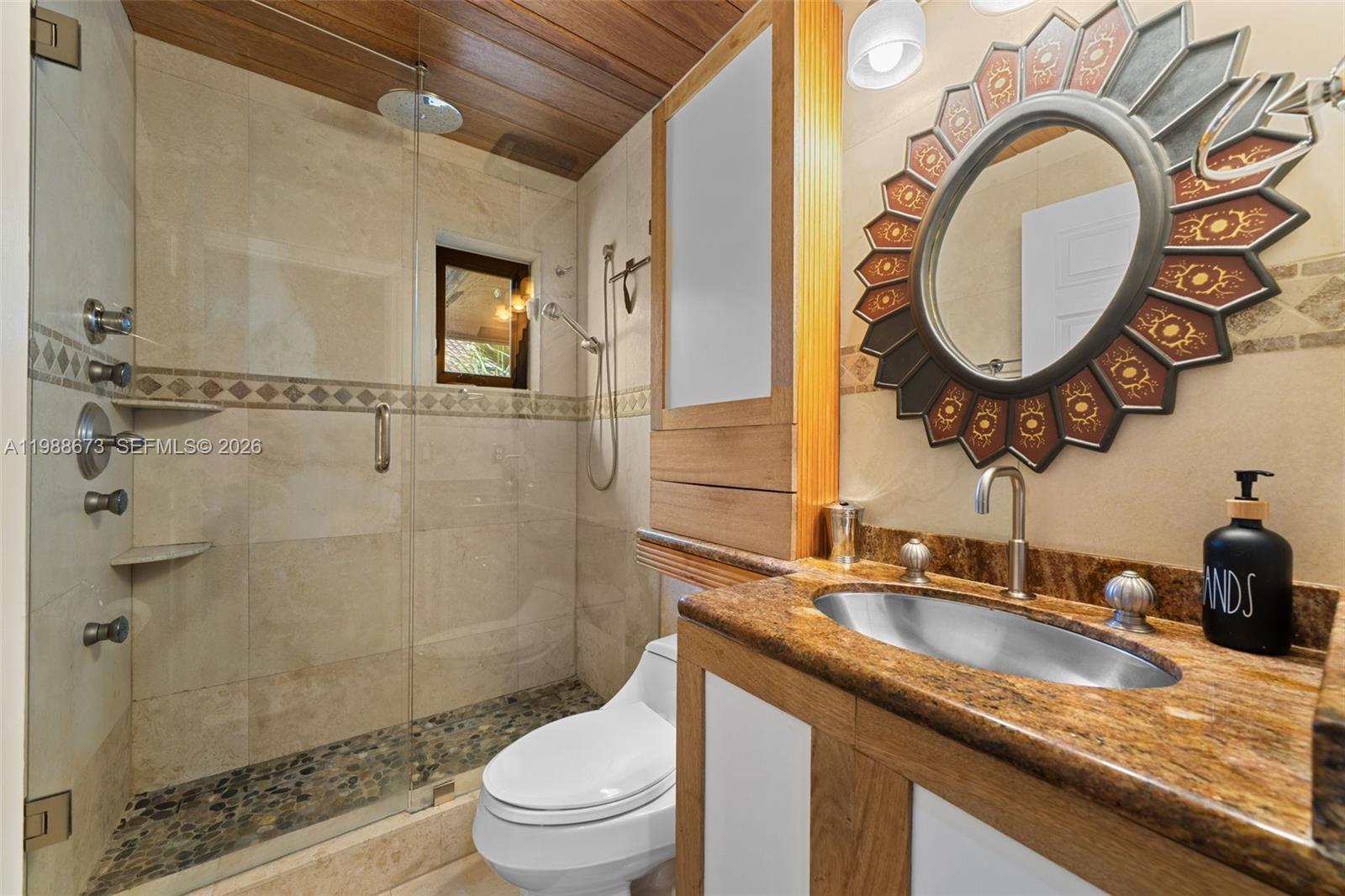 14888 Southwest 140th Street Miami, FL 33196 - Photo 13 of 76 a bathroom with a granite countertop toilet a sink and a mirror