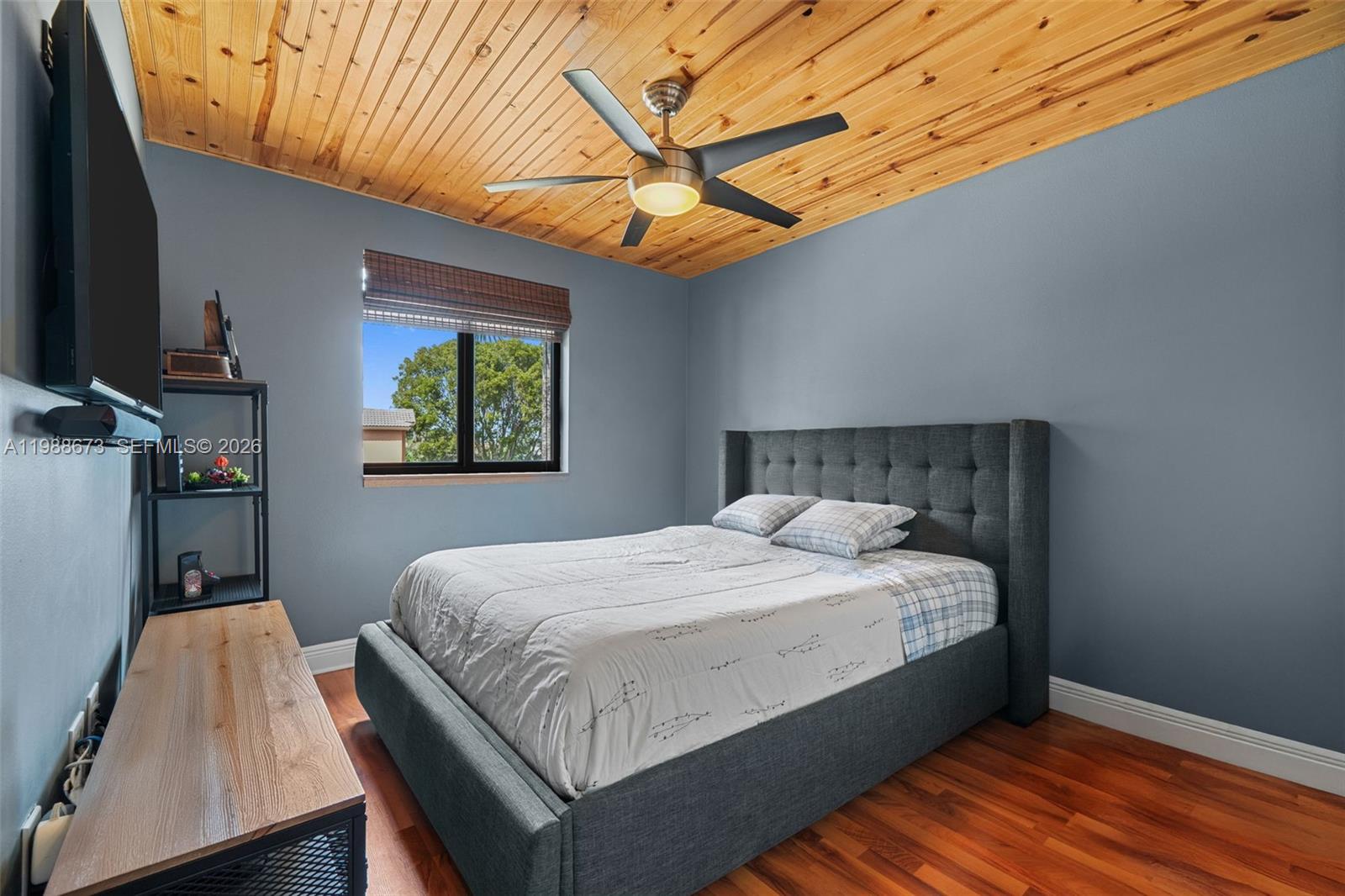 14888 Southwest 140th Street Miami, FL 33196 - Photo 14 of 76 a bedroom with a bed and wooden floor