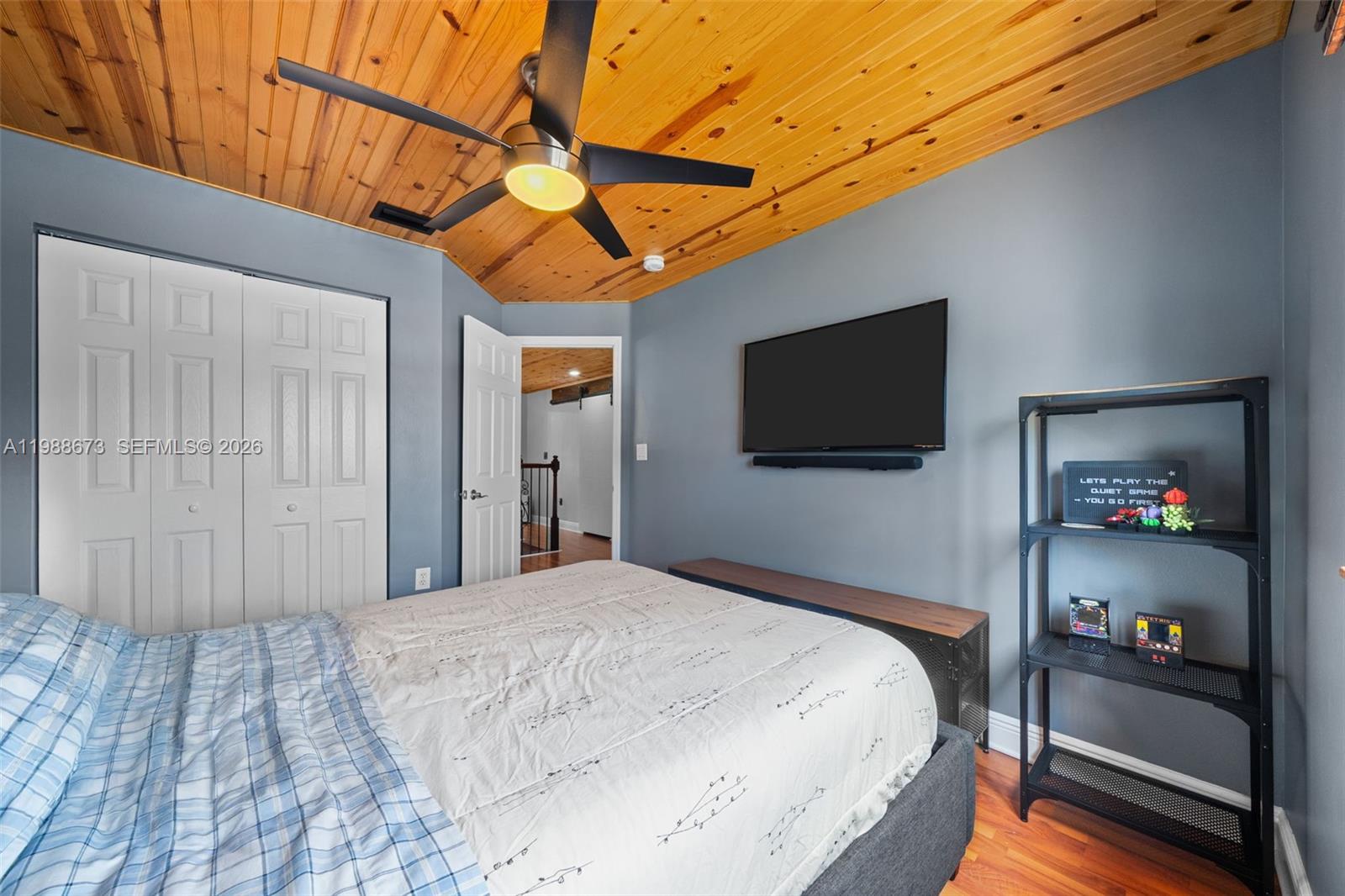 14888 Southwest 140th Street Miami, FL 33196 - Photo 15 of 76 a bedroom with a bed and a flat screen tv