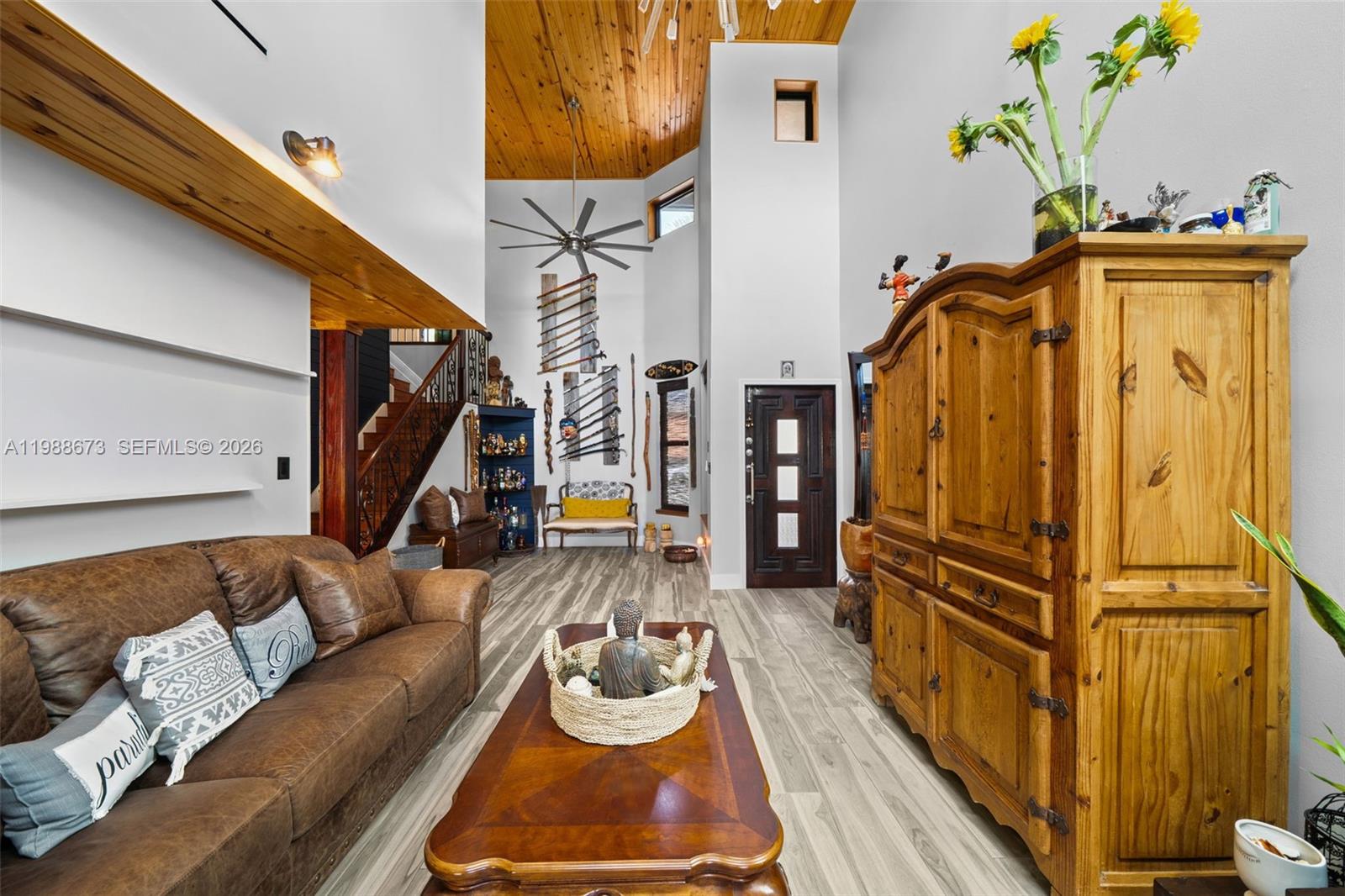 14888 Southwest 140th Street Miami, FL 33196 - Photo 20 of 76 a living room with furniture a rug and white walls