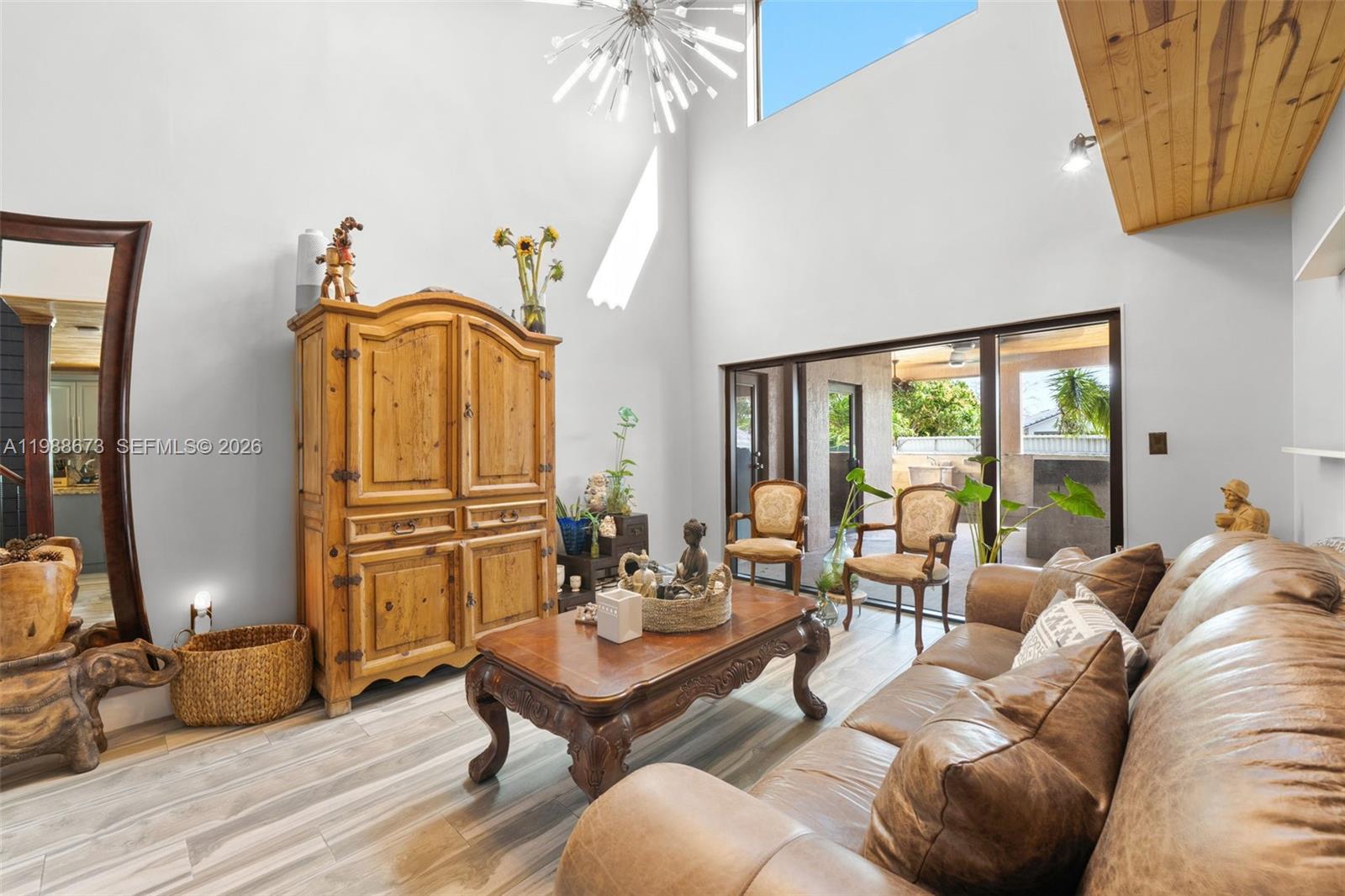 14888 Southwest 140th Street Miami, FL 33196 - Photo 23 of 76 a living room with furniture a window and a chandelier