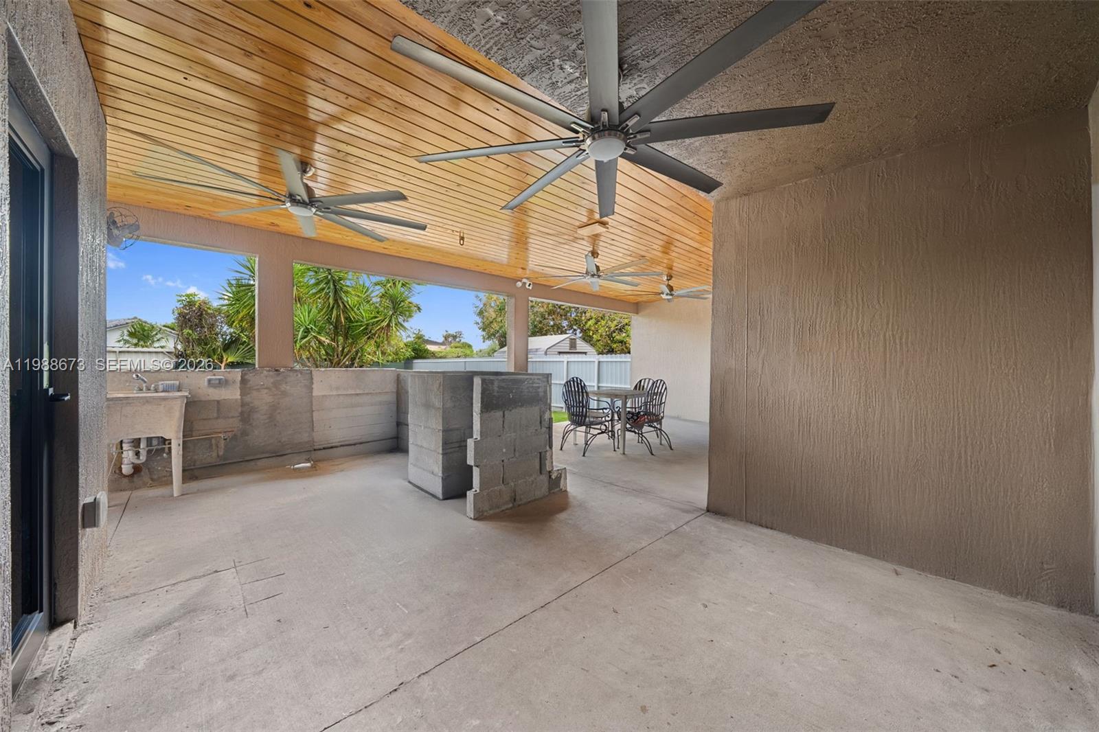 14888 Southwest 140th Street Miami, FL 33196 - Photo 28 of 76 a view of a chairs and table in backyard