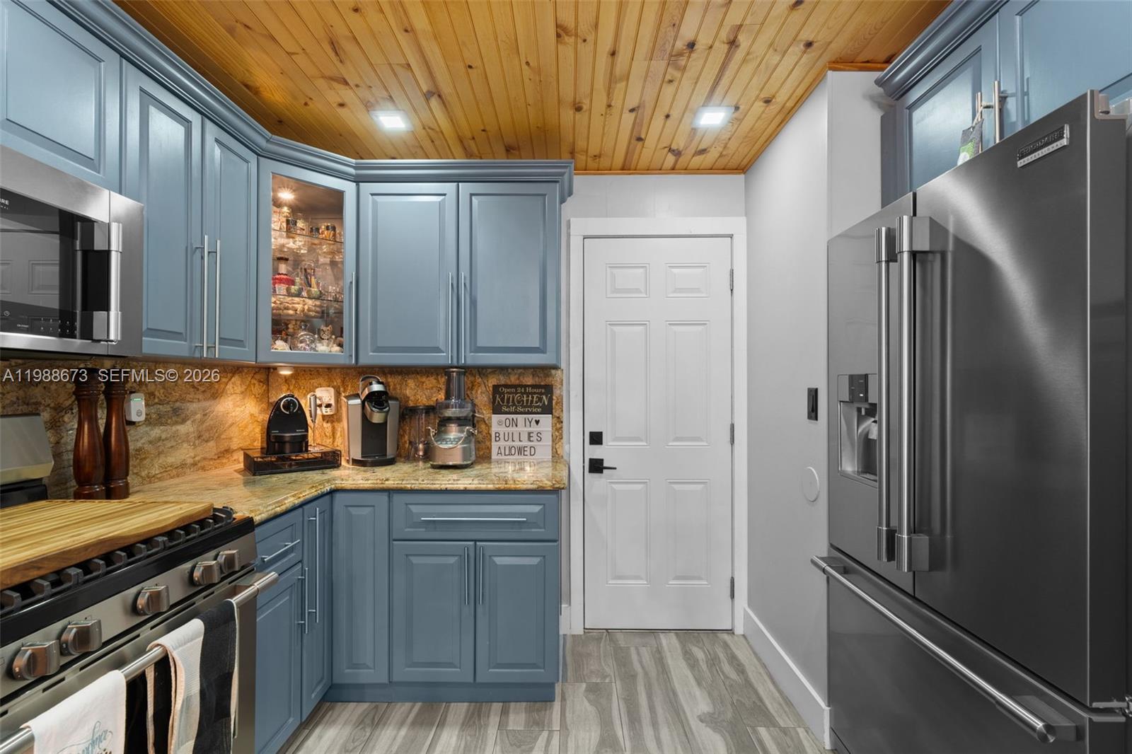 14888 Southwest 140th Street Miami, FL 33196 - Photo 44 of 76 a kitchen with stainless steel appliances granite countertop a refrigerator and a sink