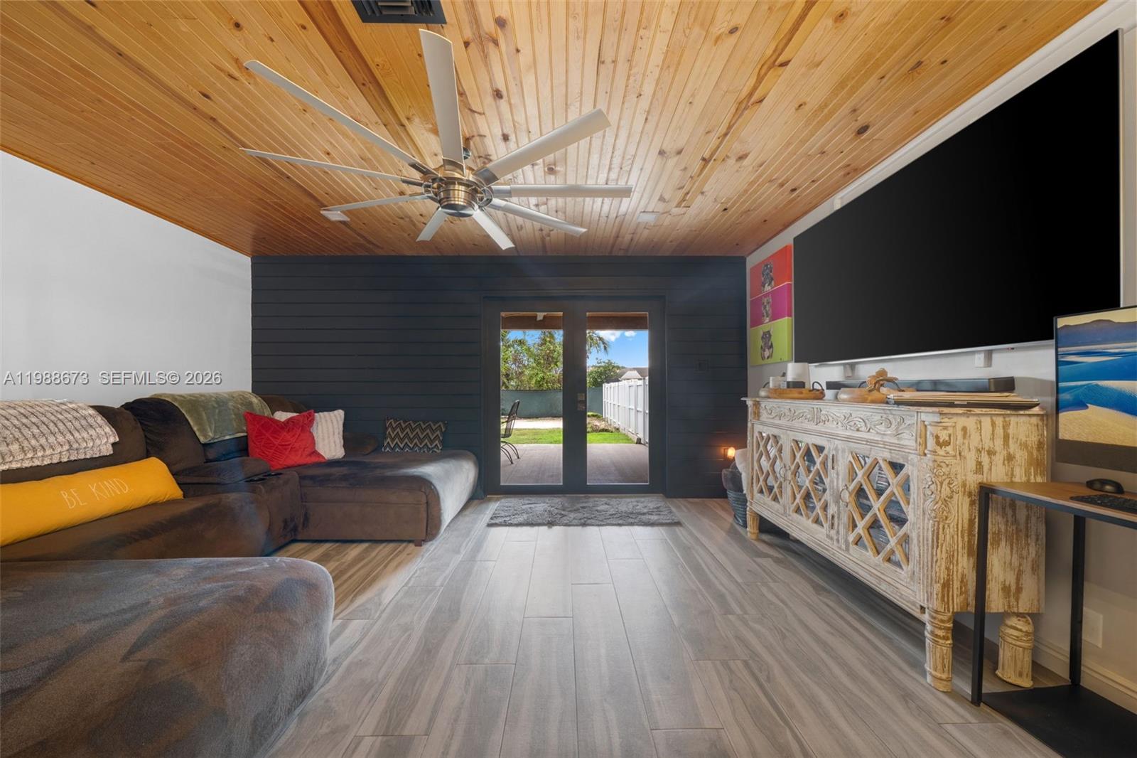 14888 Southwest 140th Street Miami, FL 33196 - Photo 47 of 76 a bed room with a bed furniture and a flat tv screen