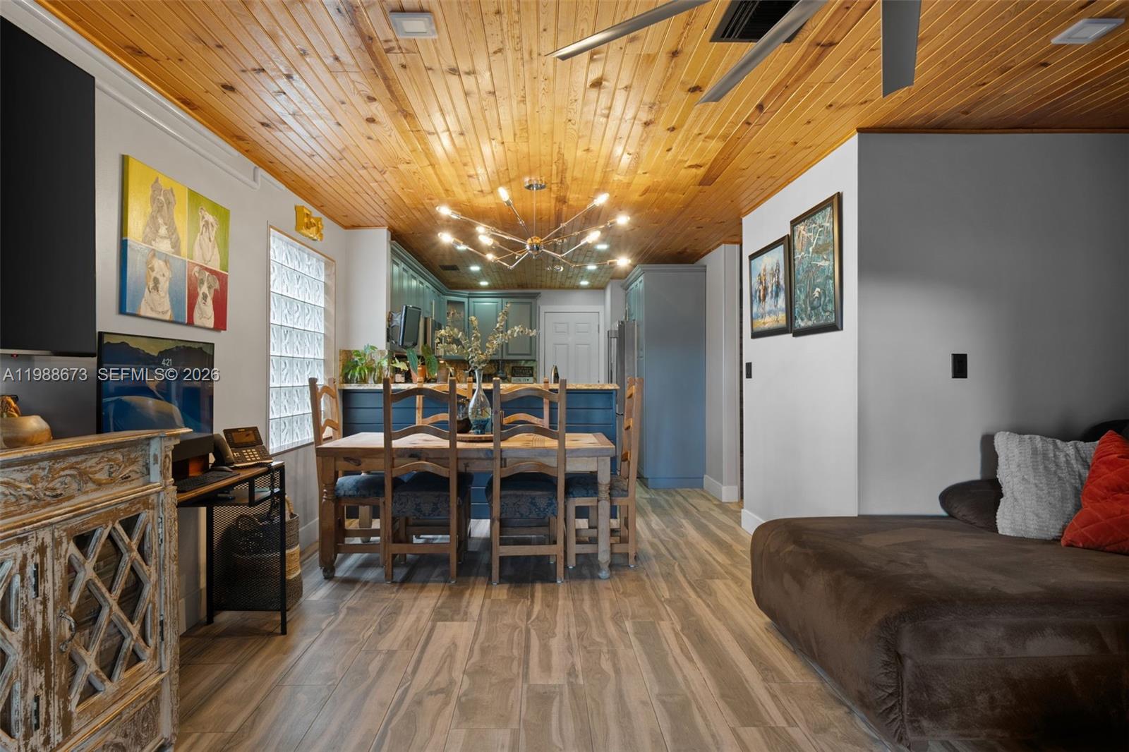 14888 Southwest 140th Street Miami, FL 33196 - Photo 49 of 76 a view of a dining room with furniture a chandelier and wooden floor