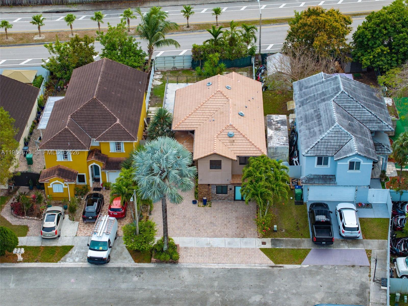 14888 Southwest 140th Street Miami, FL 33196 - Photo 67 of 76 an aerial view of multiple houses with a yard