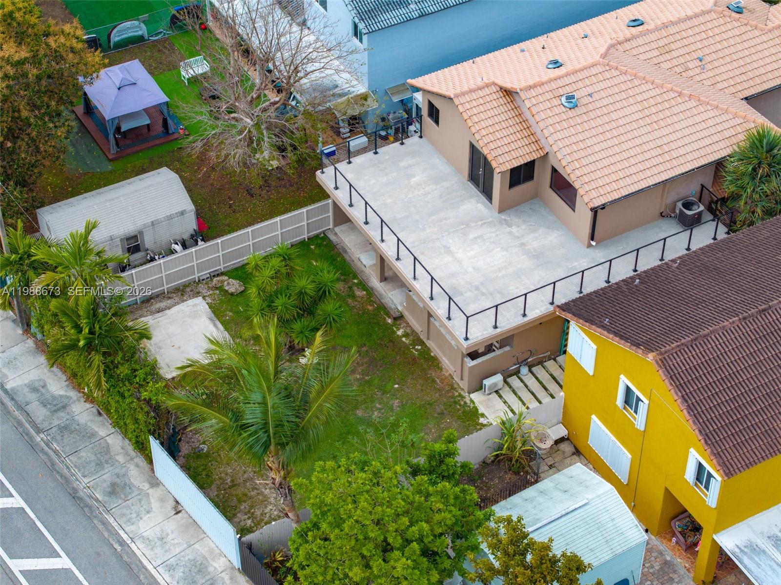 14888 Southwest 140th Street Miami, FL 33196 - Photo 76 of 76 an aerial view of a house with a yard and potted plants