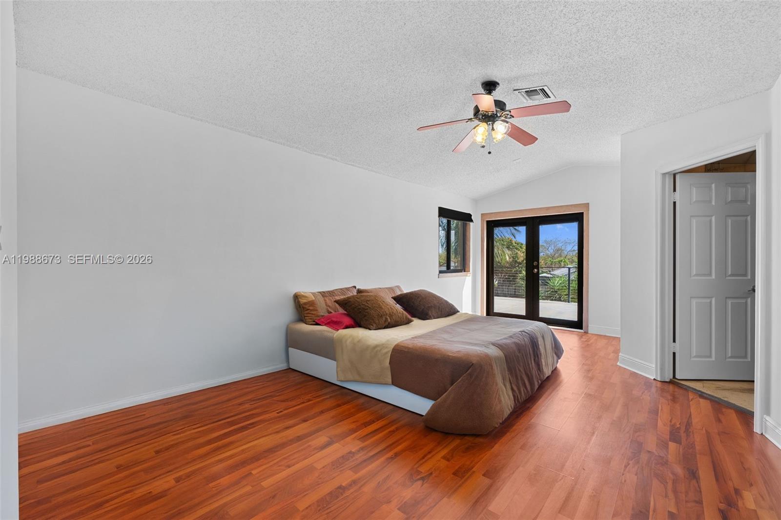 14888 Southwest 140th Street Miami, FL 33196 - Photo 8 of 76 a bedroom with a bed and wooden floor