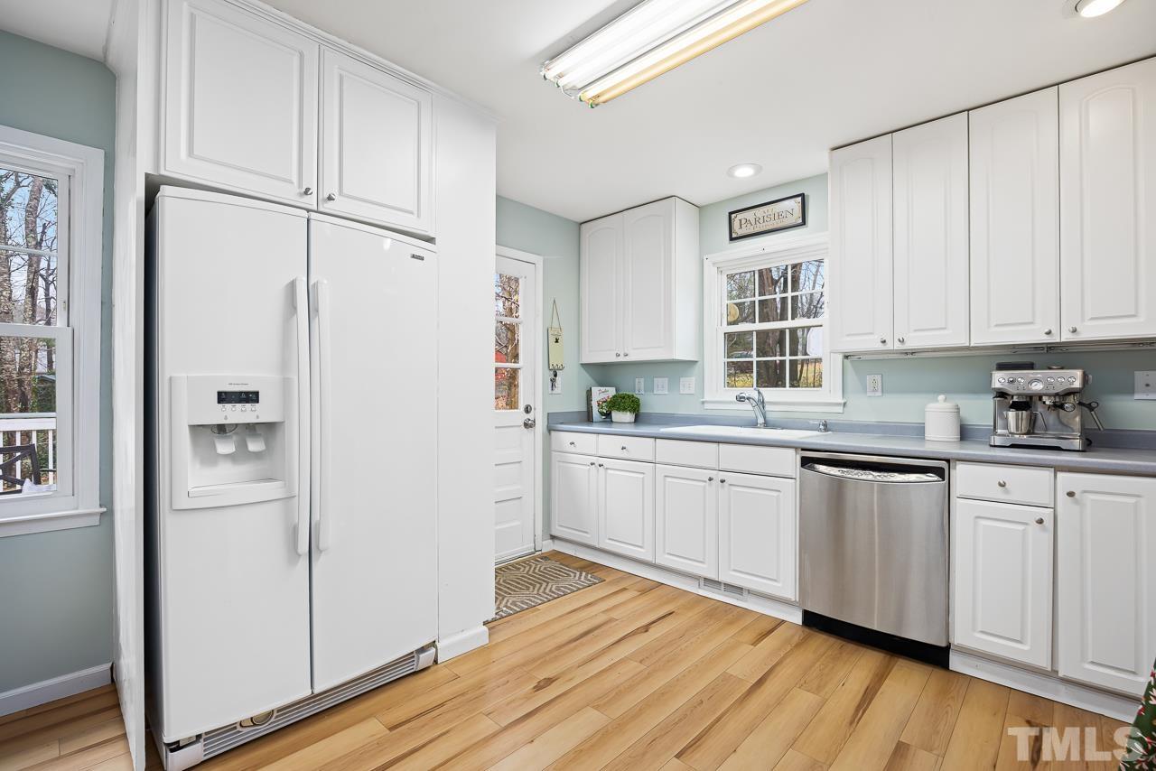 505 Sawmill Road Raleigh, NC 27615 - Photo 7 of 21 a kitchen with granite countertop white cabinets and white stainless steel appliances