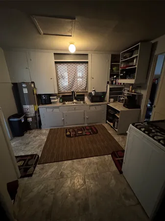 a kitchen with sink refrigerator and stove